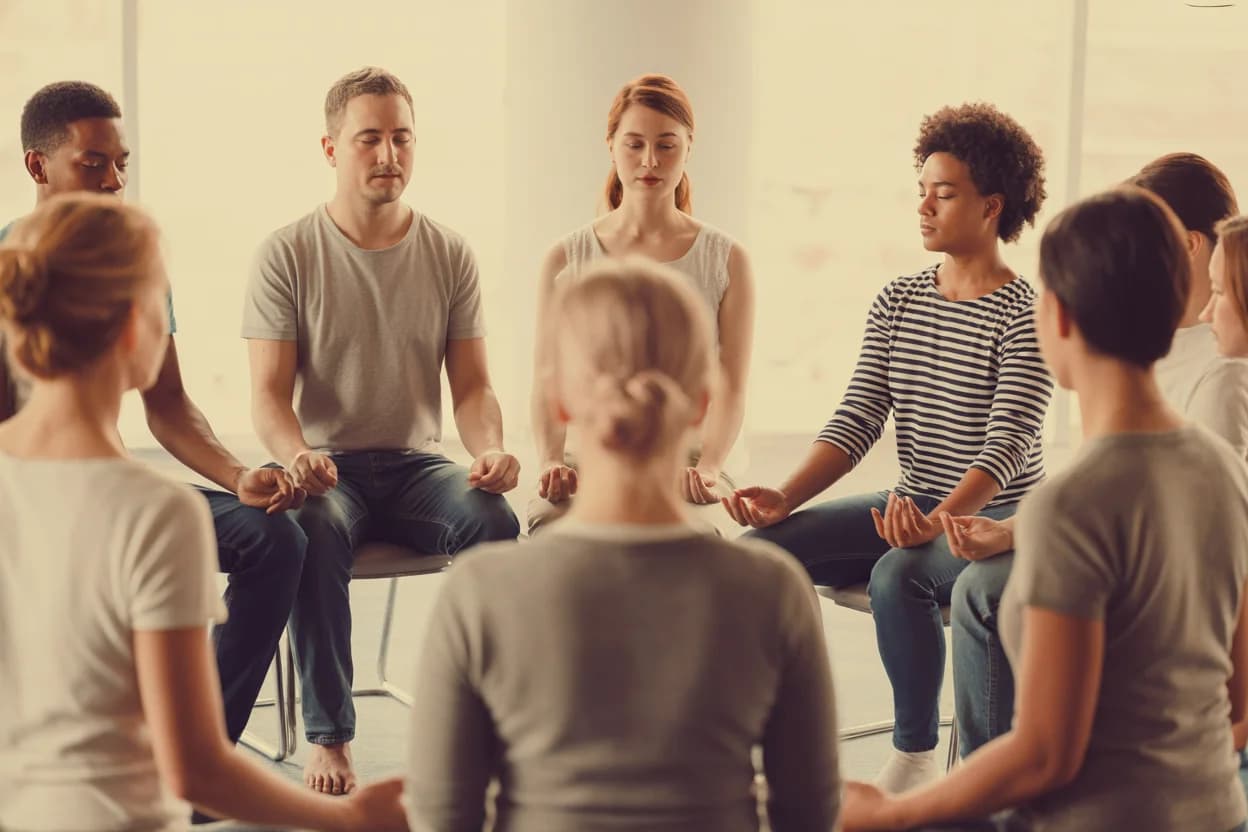 Group practicing mindfulness and MBSR® in a bright room